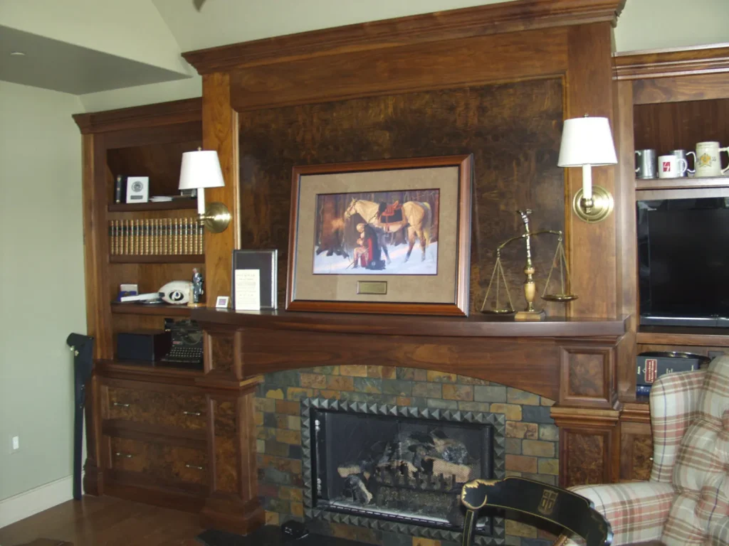 Custom wood fireplace mantel with built-in cabinetry and shelving by Flegel Woodcraft