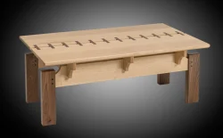 Rectangular wooden coffee table with contrasting legs and decorative inlay across the top surface.
