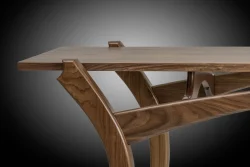 Close-up of a modern wooden table with smooth, angular legs and a polished finish against a gradient background.