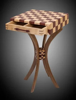 Wooden chessboard table with two open drawers, featuring curved legs and a checkered design on the tabletop.