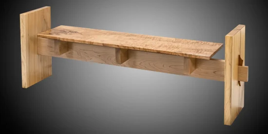 A wooden bench with thick, flat end panels and a rectangular seat, featuring three triangular support braces underneath.